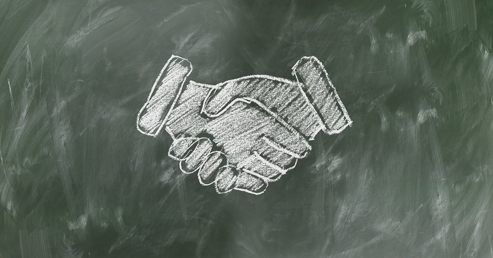 Chalkboard handshake drawing employee