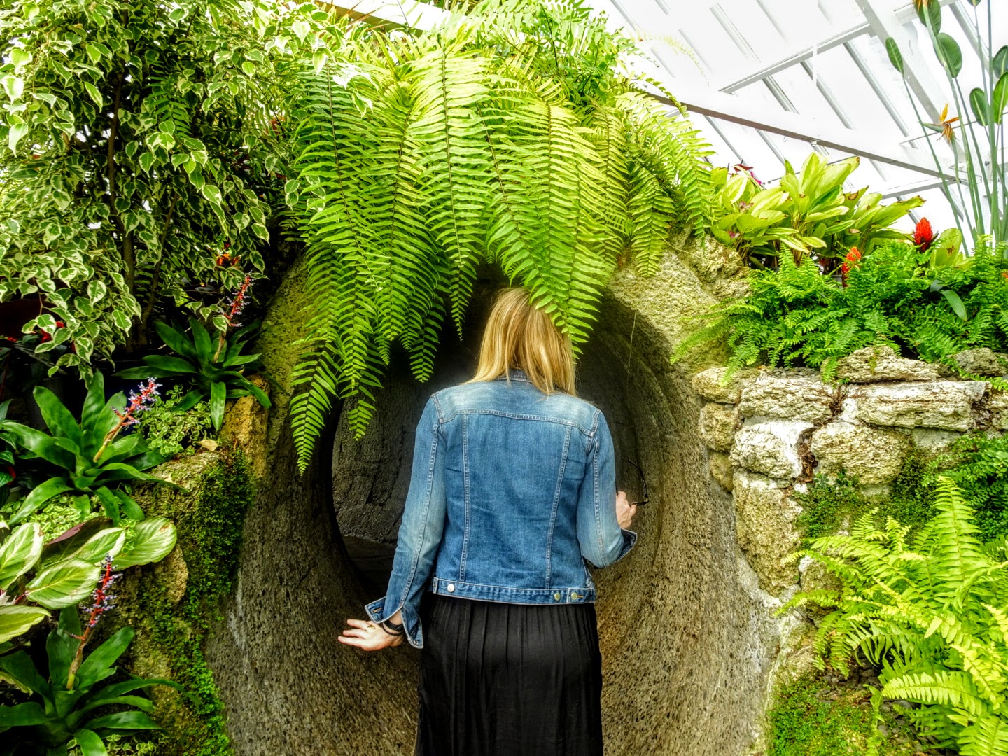 Girl looking through tunnel with nice scenery