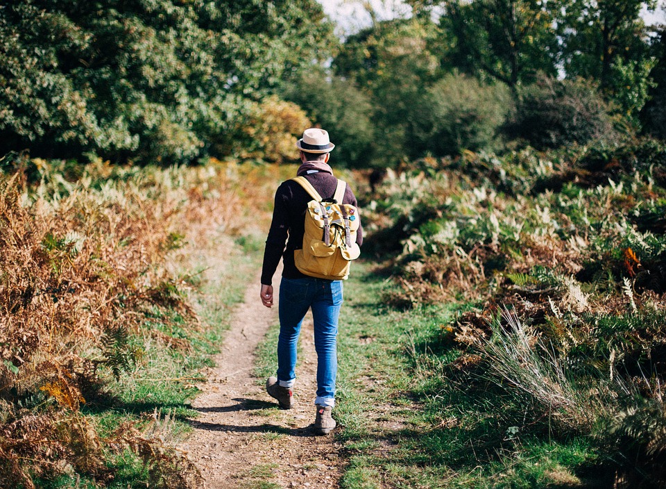 Person walking with backpack on