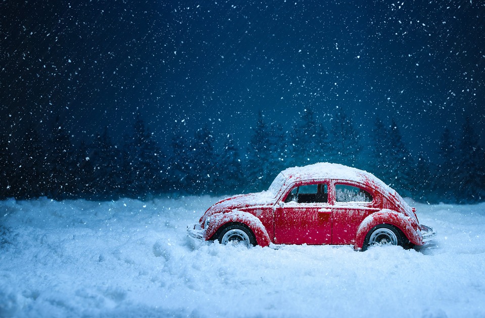 example of snowy weather, snow pouring all over a car